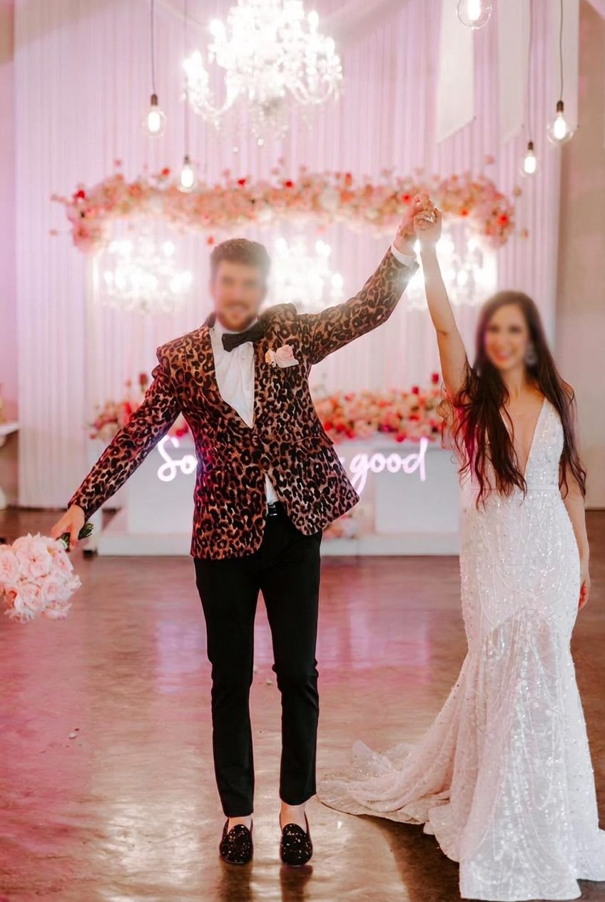 Couple wearing a custom-made leopard-print tuxedo and beaded wedding dress by Jet Smart Tailor
